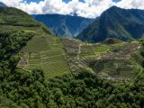 Aerial view of the Machu Picchu citadel and terraces surrounded by cloud forest mountains