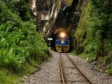 PeruRail train emerging from a rock tunnel on the way to Machu Picchu