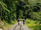 Travelers walking along the railway tracks from Hidroelectrica to Aguas Calientes