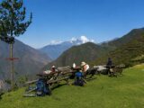 Hikers resting at a scenic viewpoint with backpacks along the Choquequirao trek
