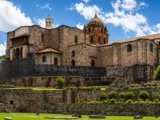 Santo Domingo convent built on top of the dark Inca stone walls of the Qorikancha temple, with terraced gardens below