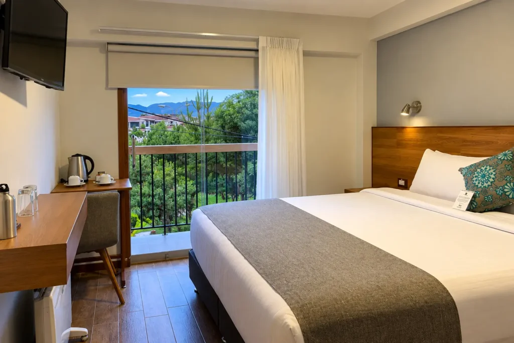 Guest room with balcony at Muru Homely Hotel in the Lucrepata neighborhood of Cusco