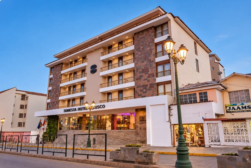 Sonesta Hotel Cusco facade at dusk, a hotel to stay in the Wanchaq neighborhood