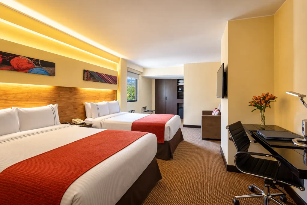 Double room at Sonesta Hotel Cusco with Andean-patterned bedding, hotel in Wanchaq