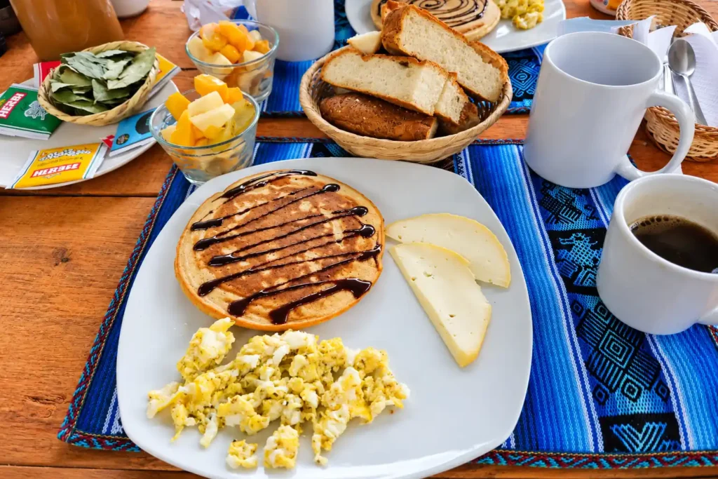 Fresh breakfast on the Choquequirao Trek: pancake, scrambled eggs, cheese, bread, fruit and coca leaves