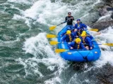 Group rafting through whitewater rapids on the Urubamba River during the Inca Jungle Trail