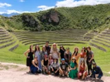 Group of travelers at the circular Inca agricultural terraces of Moray in Peru's Sacred Valley