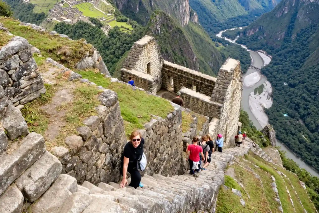 Huayna Picchu hike up steep stone stairs with a view of Machu Picchu and the Urubamba River