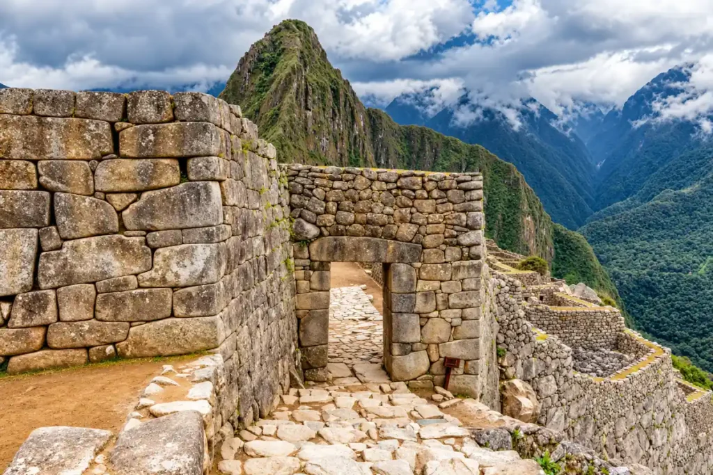 How Machu Picchu was built: Inca stone walls without mortar and the main city gate, with Huayna Picchu behind