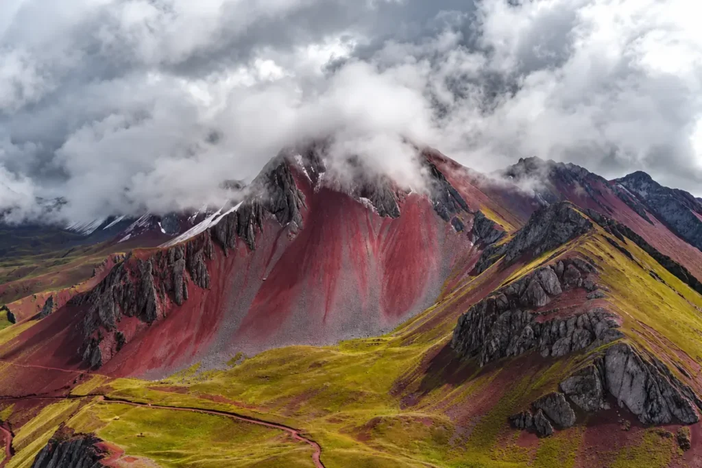 Pallay Punchu red mountain under heavy clouds in the rainy season